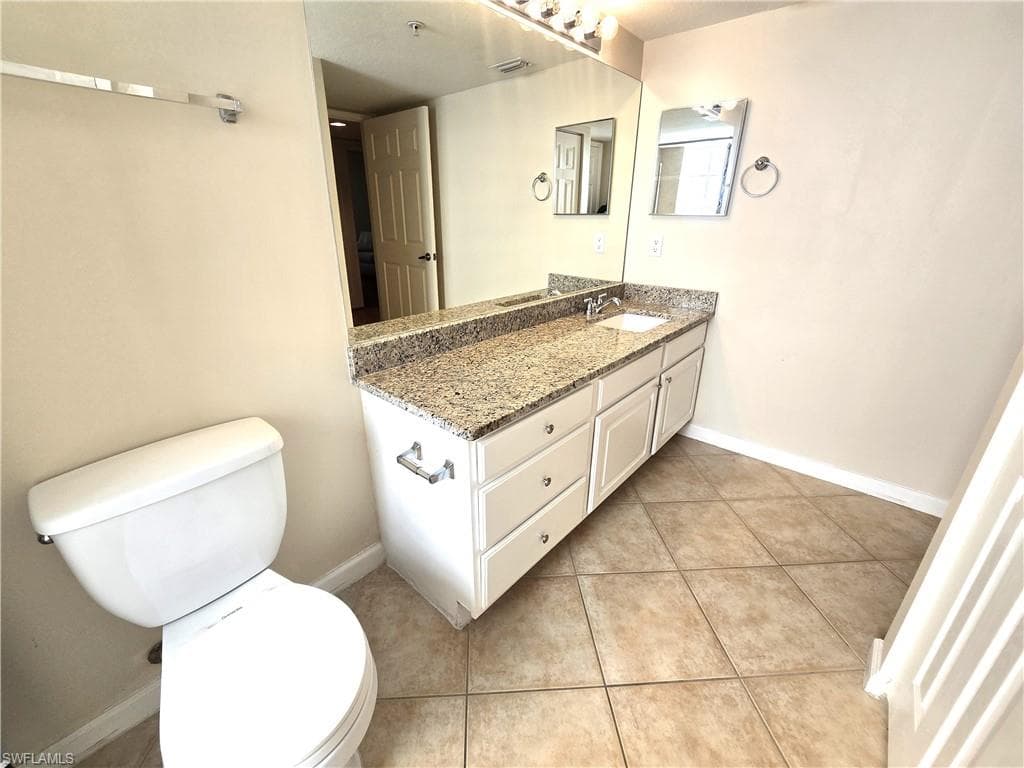 Extra wide vanity with one sink, tile on diagonal, linen closet