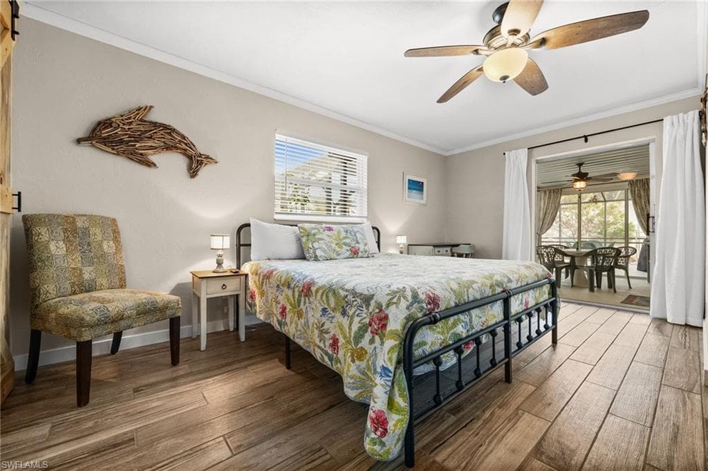 Bedroom featuring access to outside, ornamental molding, hardwood / wood-style flooring, and ceiling fan
