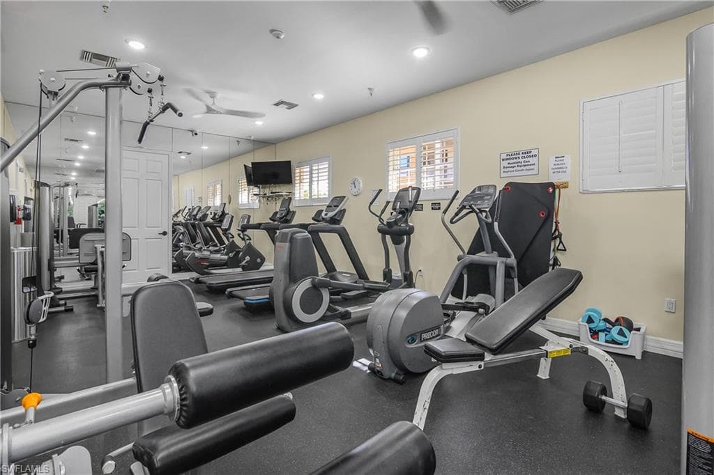 Gym with ceiling fan and recessed lighting