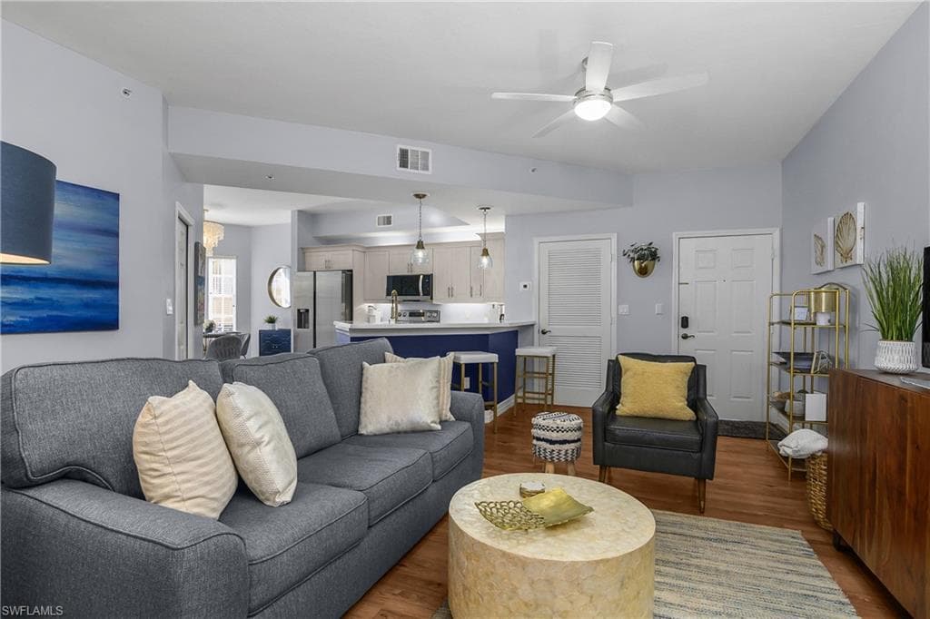 Living room featuring dark wood finished floors and a ceiling fan