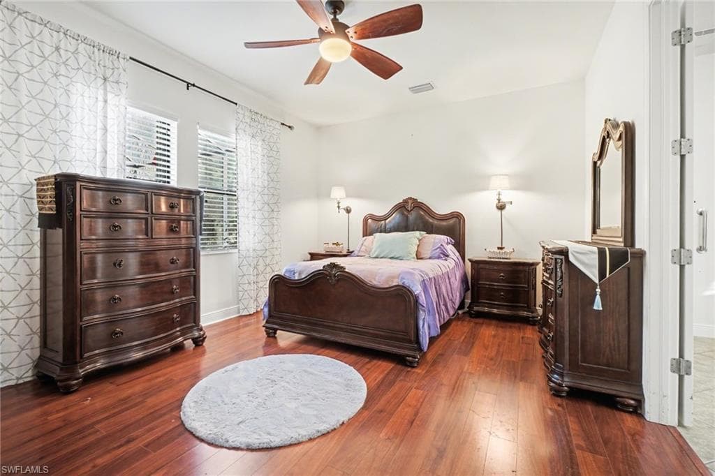 Bedroom featuring ceiling fan and dark wood finished floors
