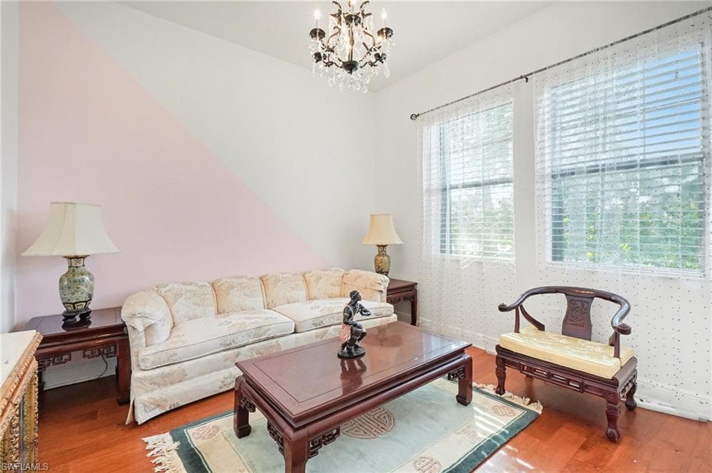 Living room with wood finished floors and a chandelier