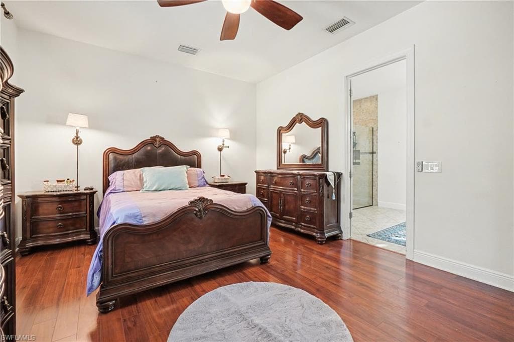 Bedroom with ceiling fan and dark wood-type flooring