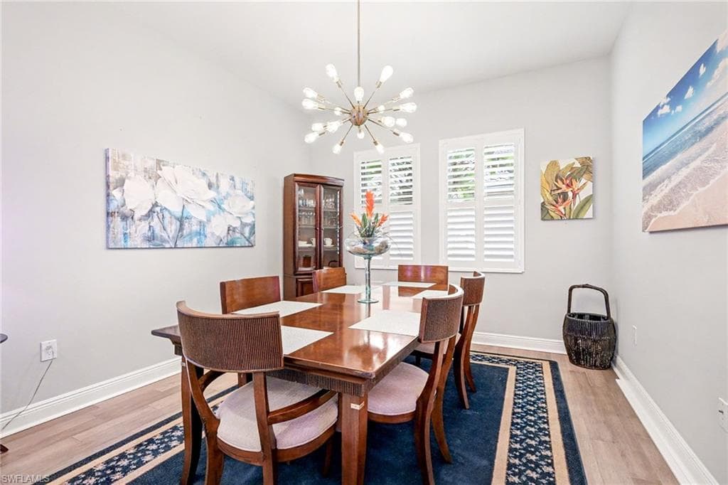 Dining room featuring light wood-style flooring and a chandelier