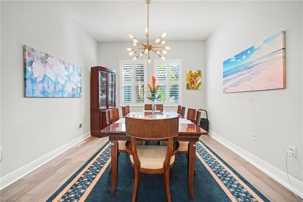 Dining space featuring a chandelier and light wood-style flooring