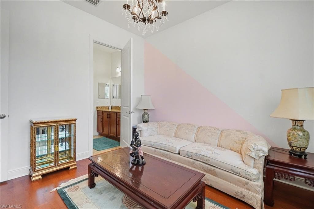 Living room featuring wood finished floors and a chandelier