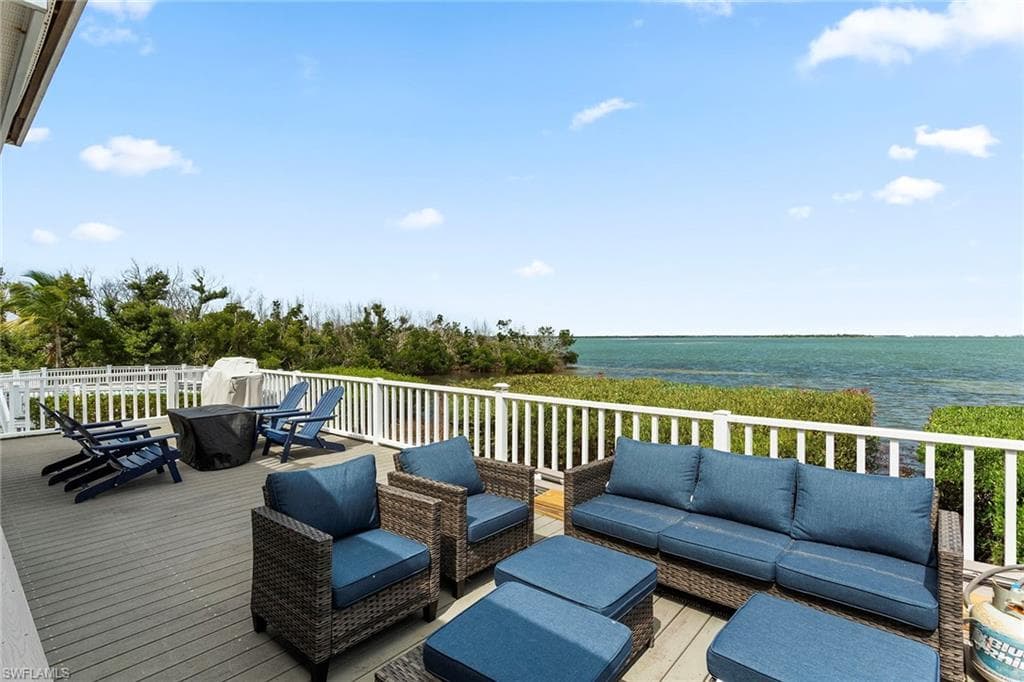 Deck featuring a water view, outdoor lounge area, and outdoor dining space