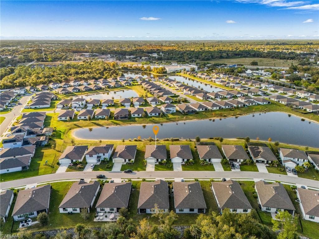 Aerial overview of property's location featuring nearby suburban area and a nearby body of water