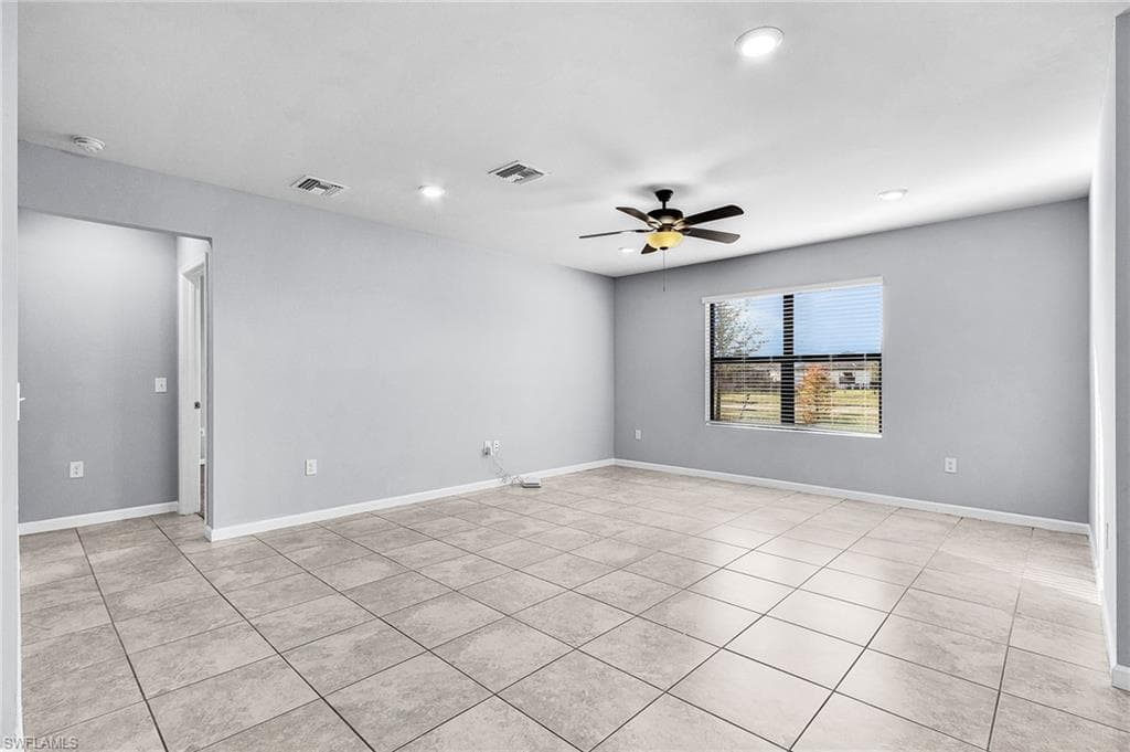 Living room featuring ceiling fan, recessed lighting, tile floors, overlooking water view