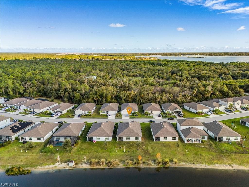 Aerial view of residential area featuring a large body of water
