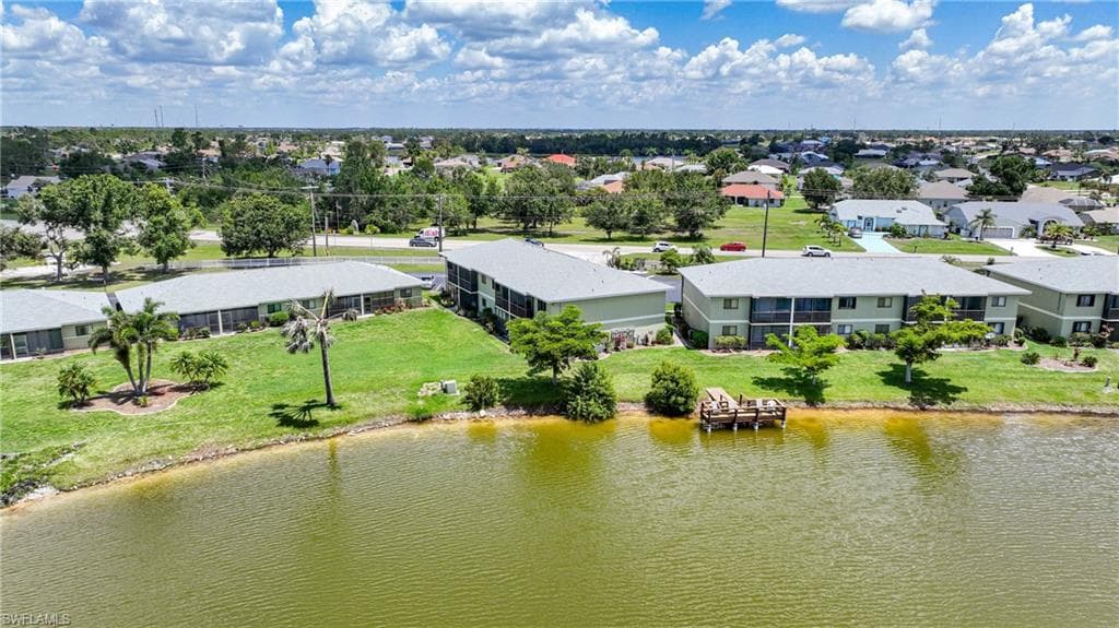 Aerial view of residential area featuring a nearby body of water