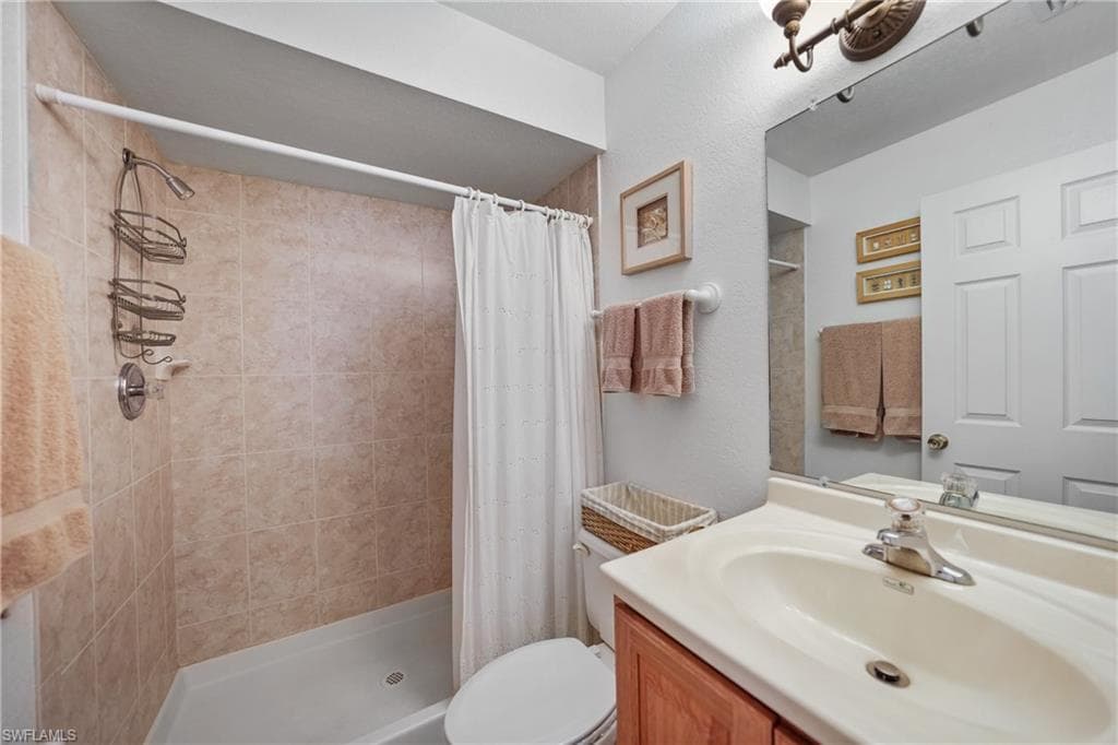 Full bath with vanity and a stall shower