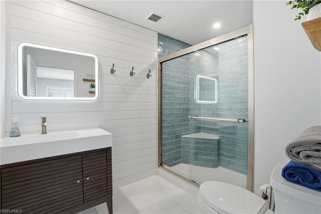 Bathroom featuring vanity, a stall shower, and tile patterned flooring - Virtually Edited Image