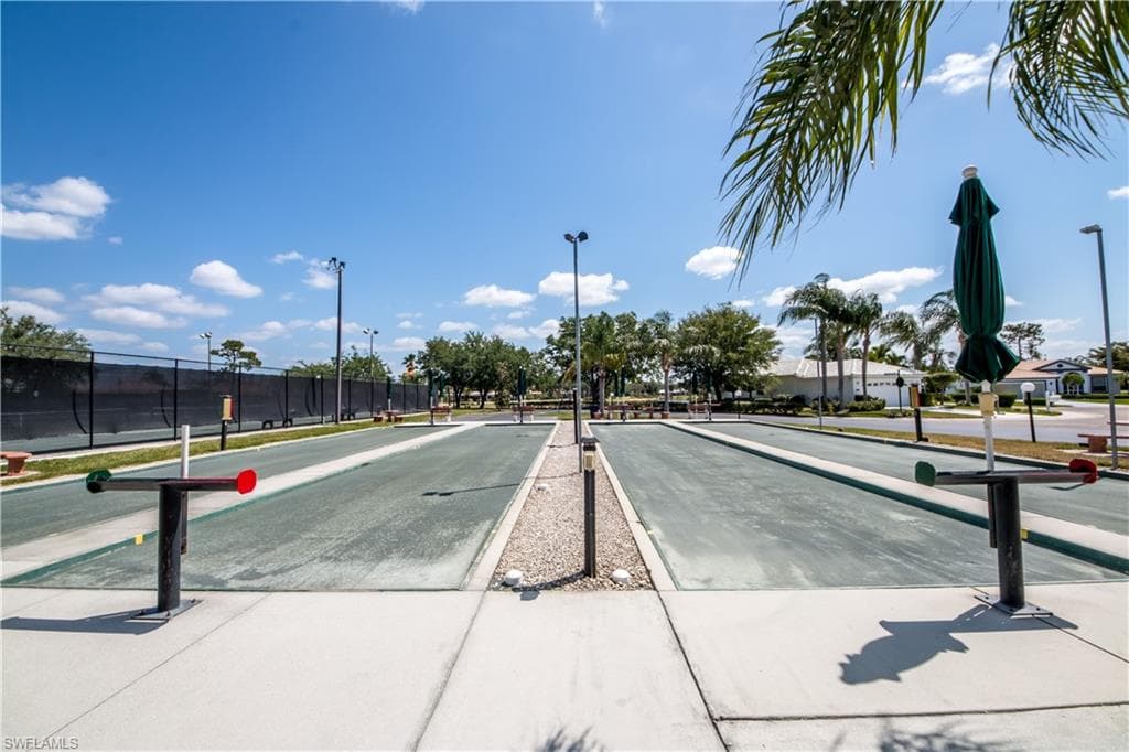 View of road featuring street lighting, traffic signs, and sidewalks