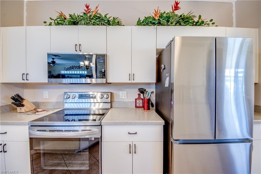 Kitchen with stainless steel appliances and white cabinets