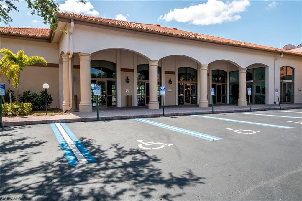 View of property featuring uncovered parking