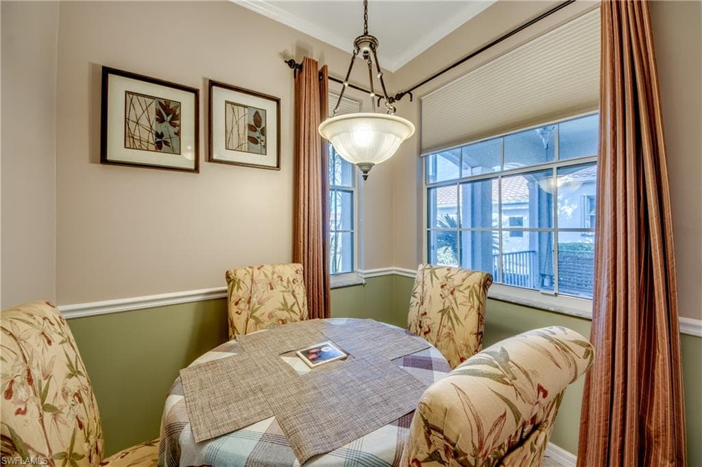 Dining space featuring crown molding