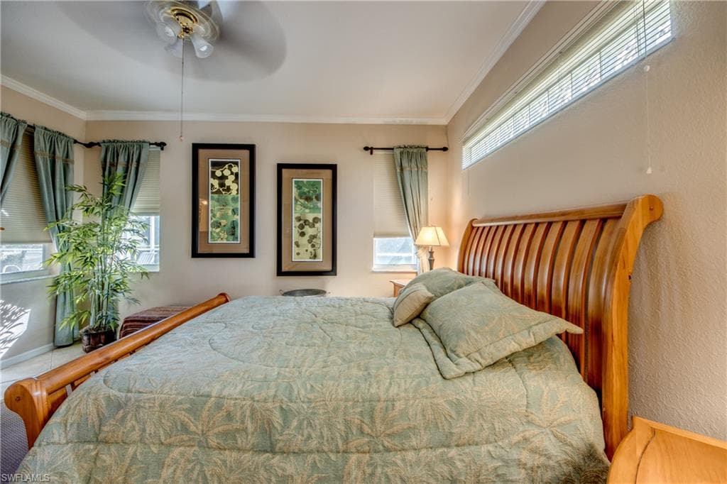 Bedroom featuring crown molding and ceiling fan