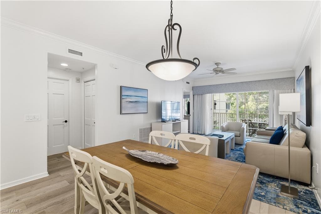 Dining area featuring ornamental molding, wood finished floors, and a ceiling fan