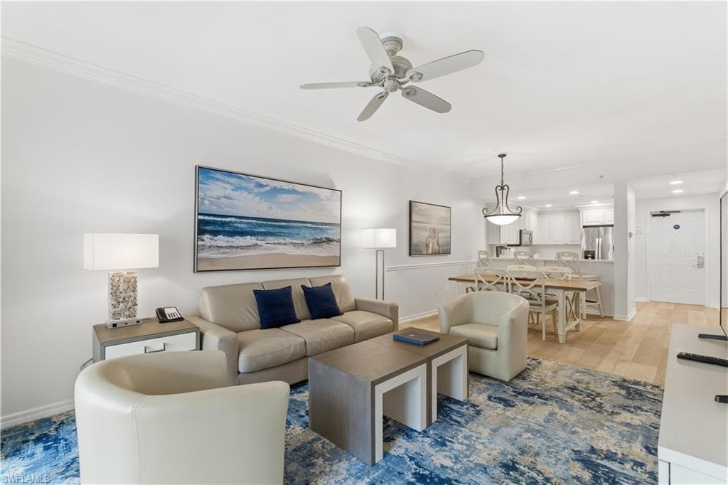 Living area with crown molding, ceiling fan, light wood-style flooring, and recessed lighting