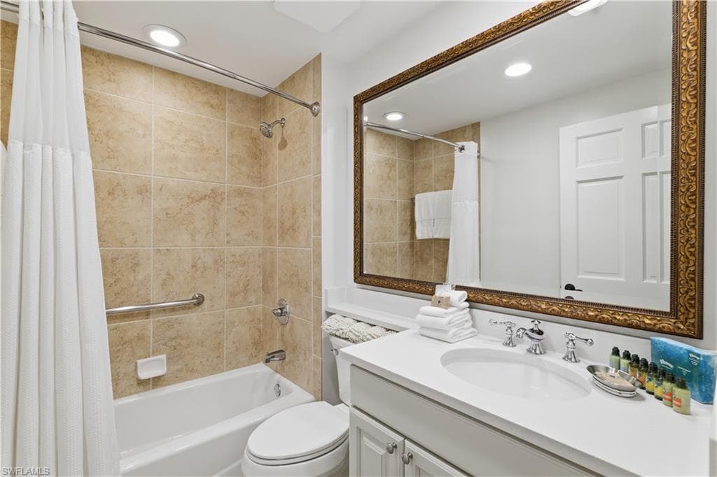 Full bath with vanity, shower / bath combo with shower curtain, and recessed lighting