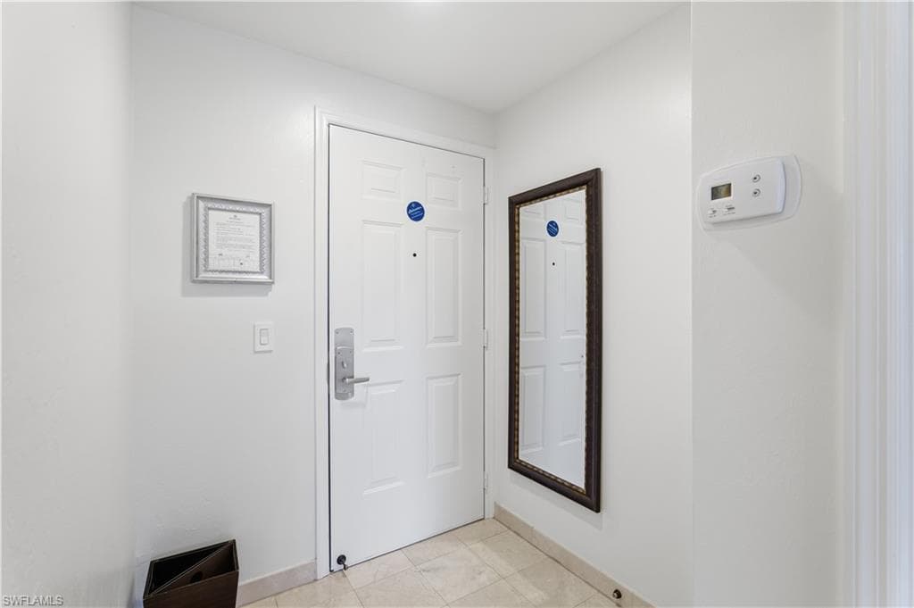 Doorway featuring baseboards