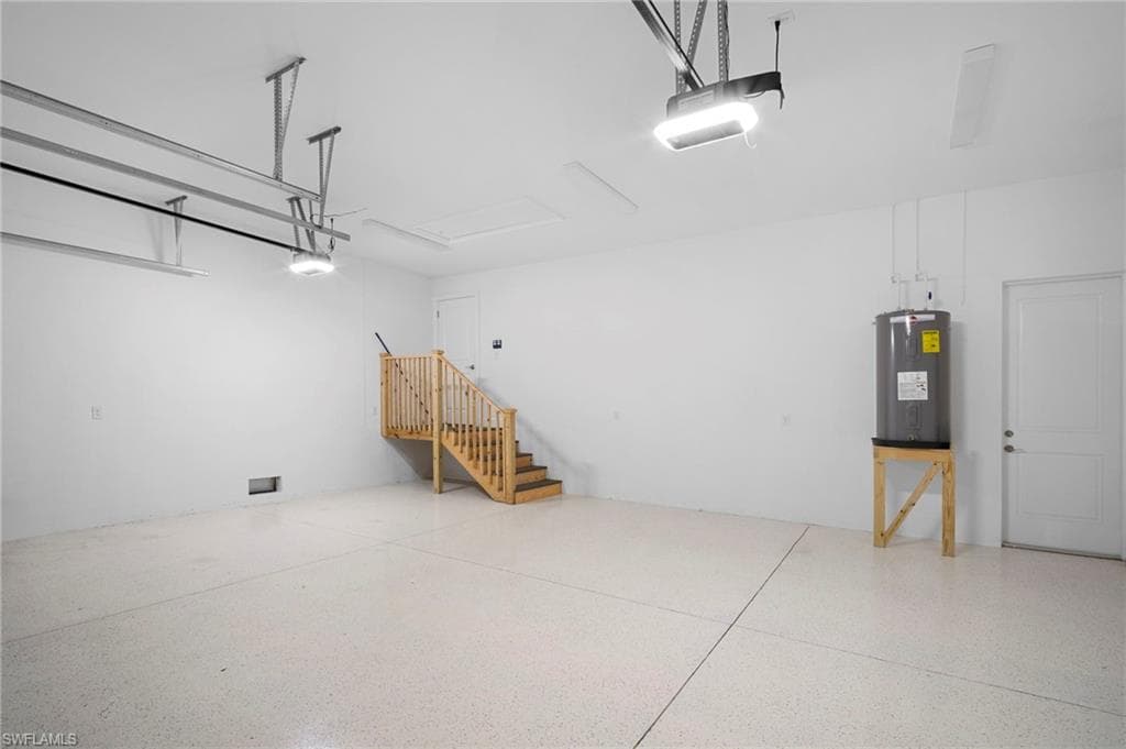 Garage with water heater and a garage door opener