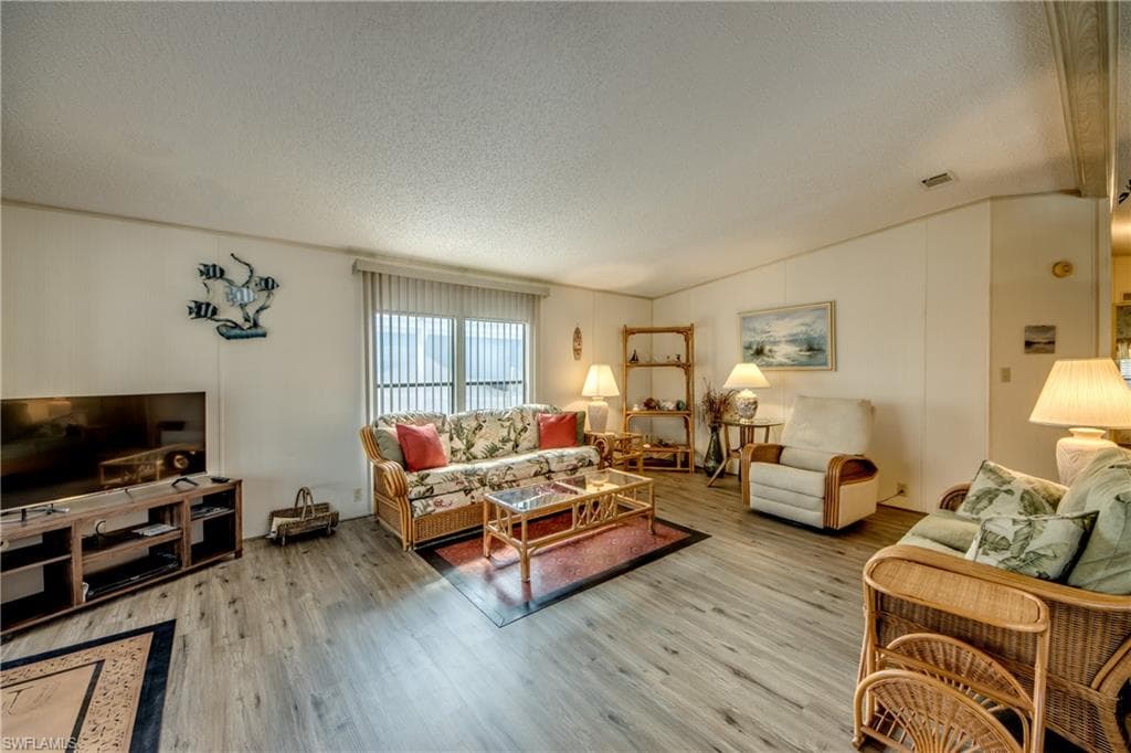Living room featuring a textured ceiling and wood finished floors