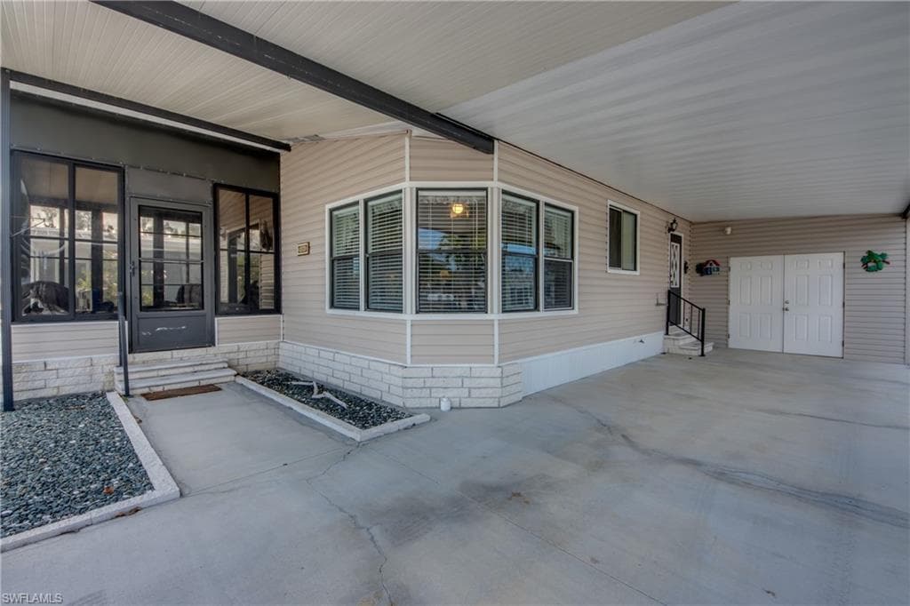 Entrance to property with an attached carport