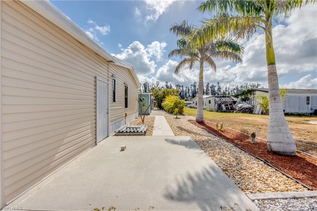 View of property exterior featuring a patio area and a residential view