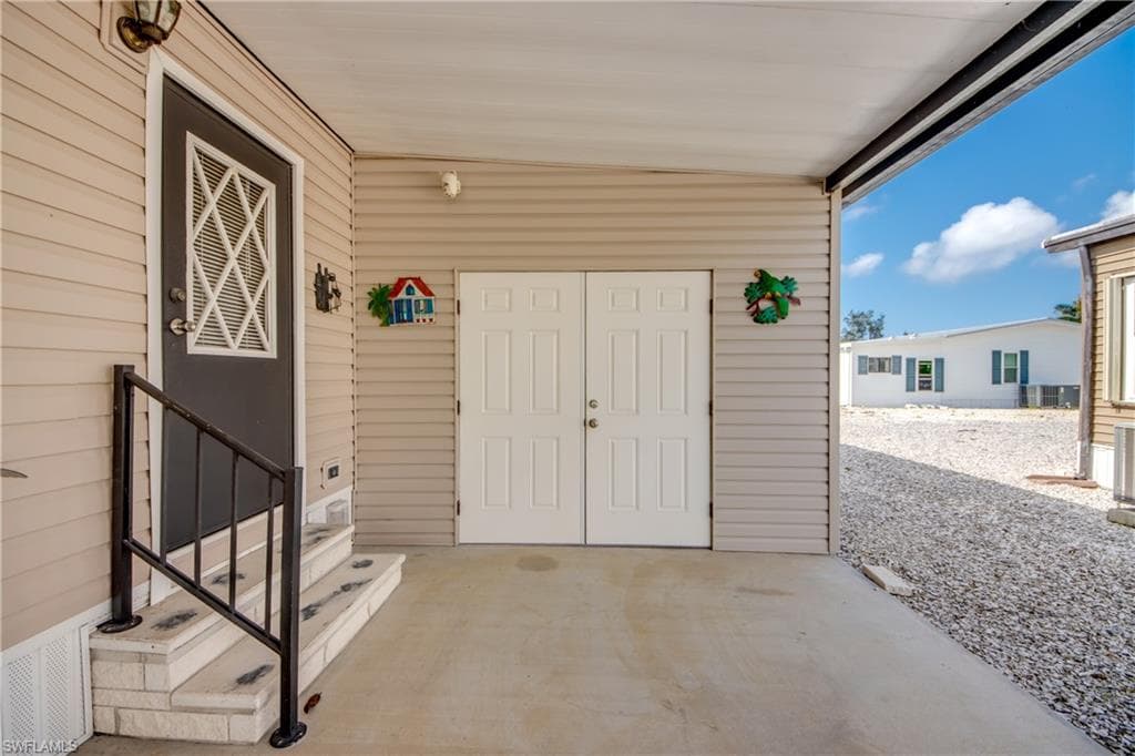 Property entrance with a patio area