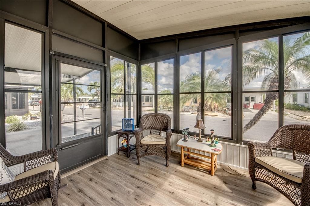 Sunroom with plenty of natural light and wood finished floors