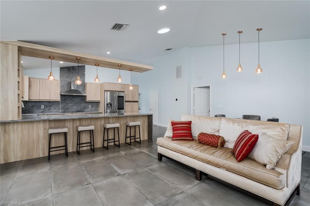 Living room with recessed lighting and vaulted ceiling