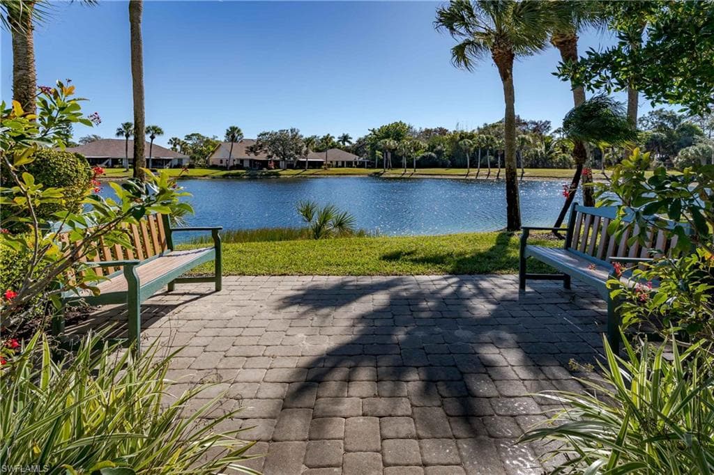 View of home's community featuring a patio, a water view, a lawn, and a residential view