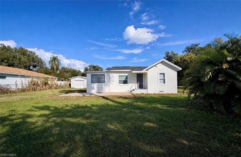 Back of property with an outbuilding