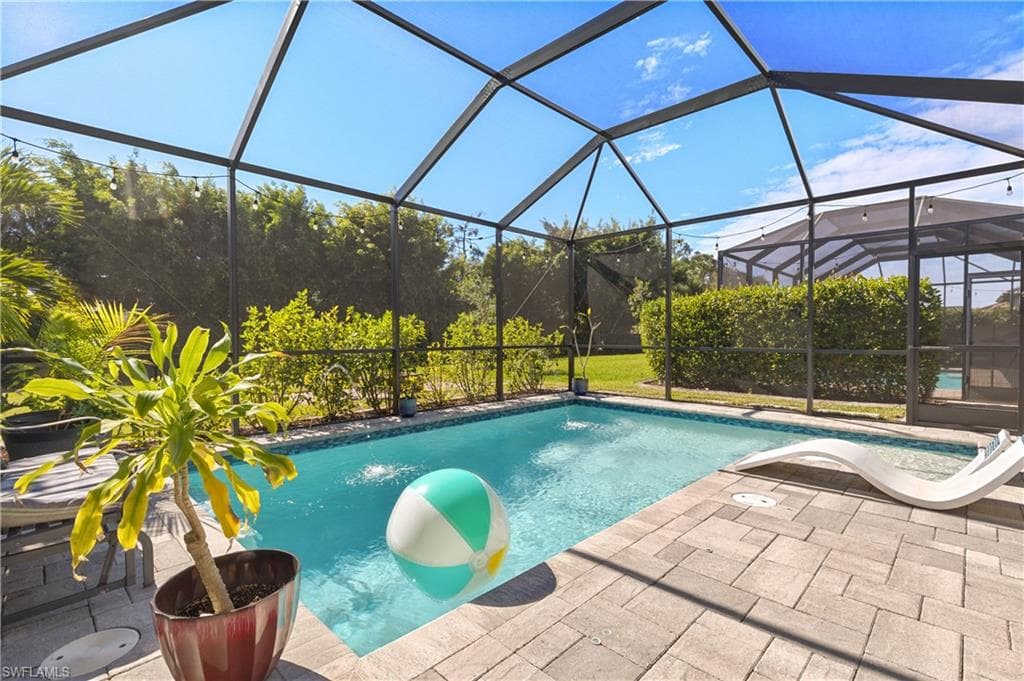Swimming pool with a lanai and a sunroom