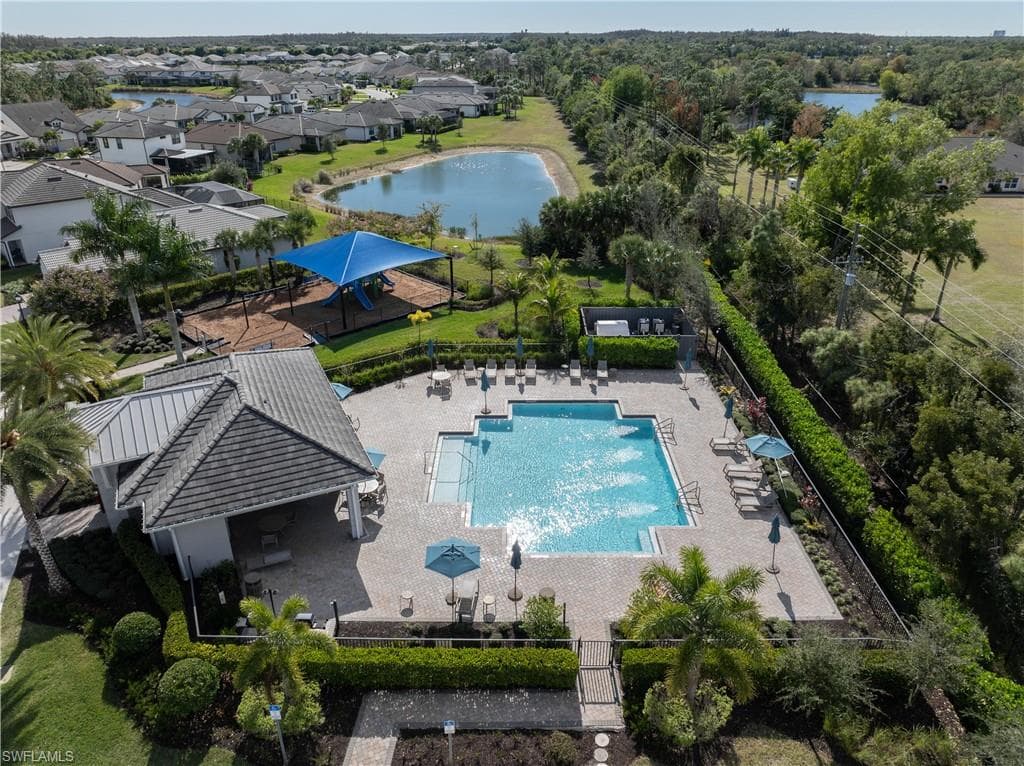 Aerial view of a pool area and a nearby body of water