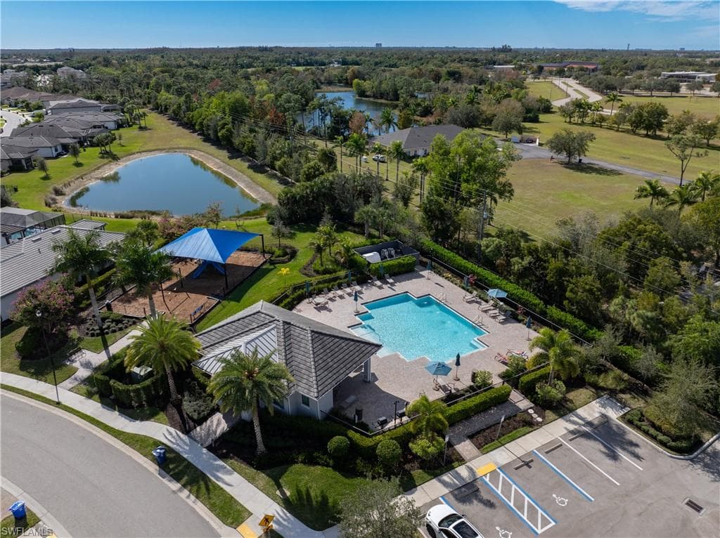 Bird's eye view of a pool and a nearby body of water