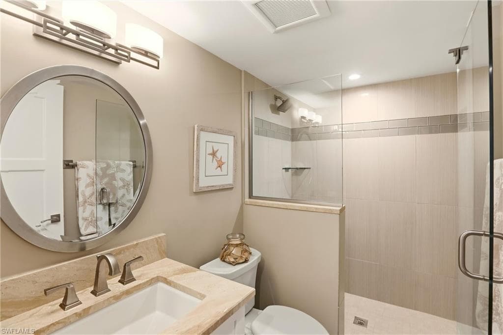 Bathroom featuring a stall shower and vanity