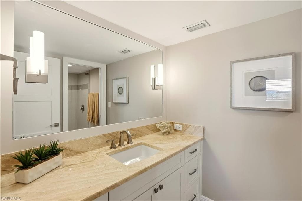 Full bathroom featuring a shower with shower curtain and vanity