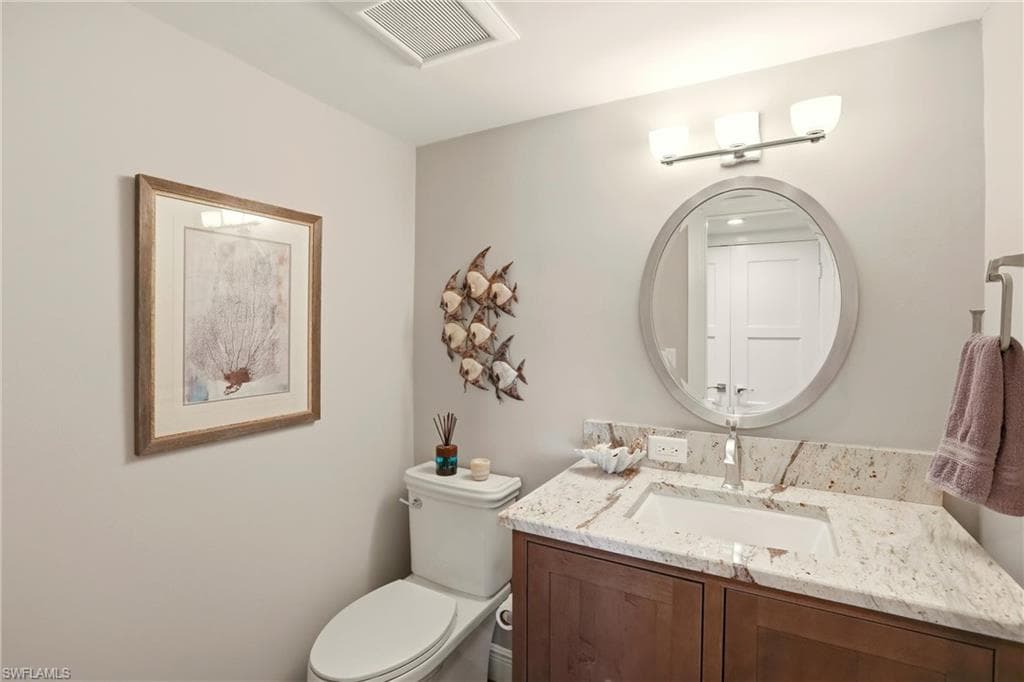 Half bath featuring vanity and toilet