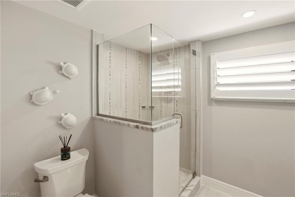 Full bath with a shower stall and recessed lighting