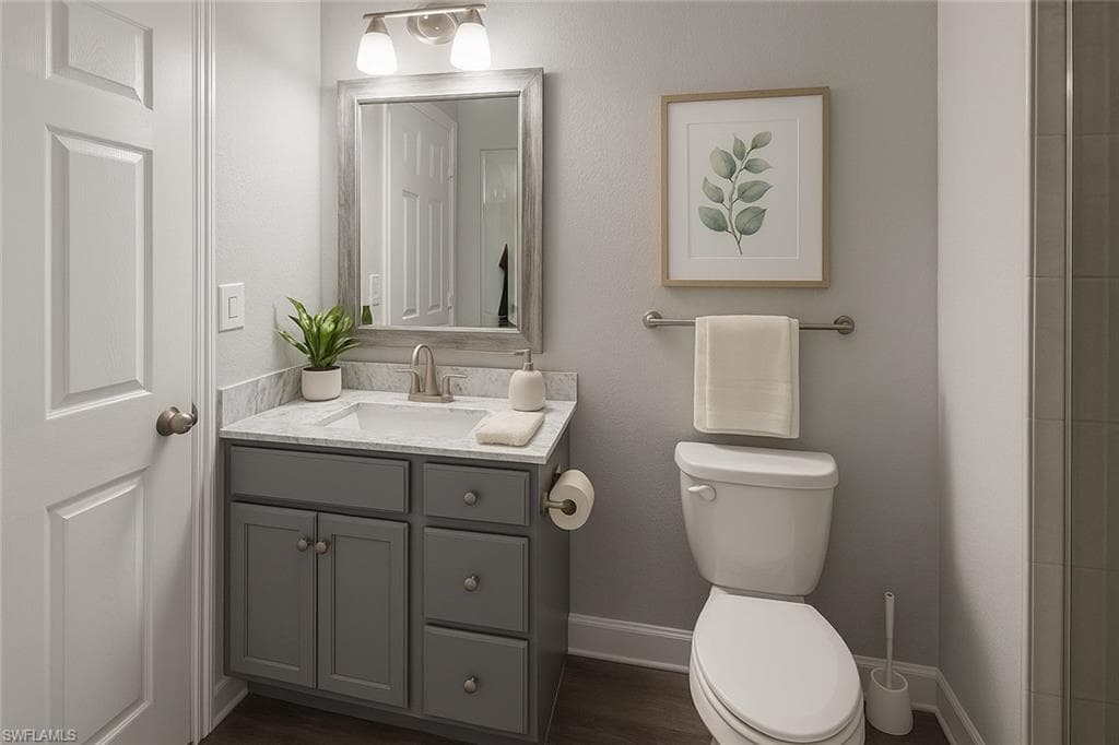 Virtually staged full bathroom featuring vanity, dark wood-style flooring, and a shower