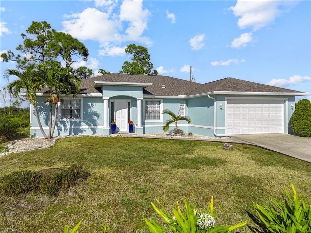 Single story home with stucco siding, a front lawn, roof with shingles, driveway, and an attached garage