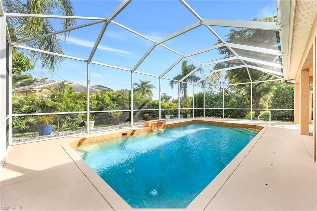 Outdoor pool featuring a sunroom, a lanai, and a patio