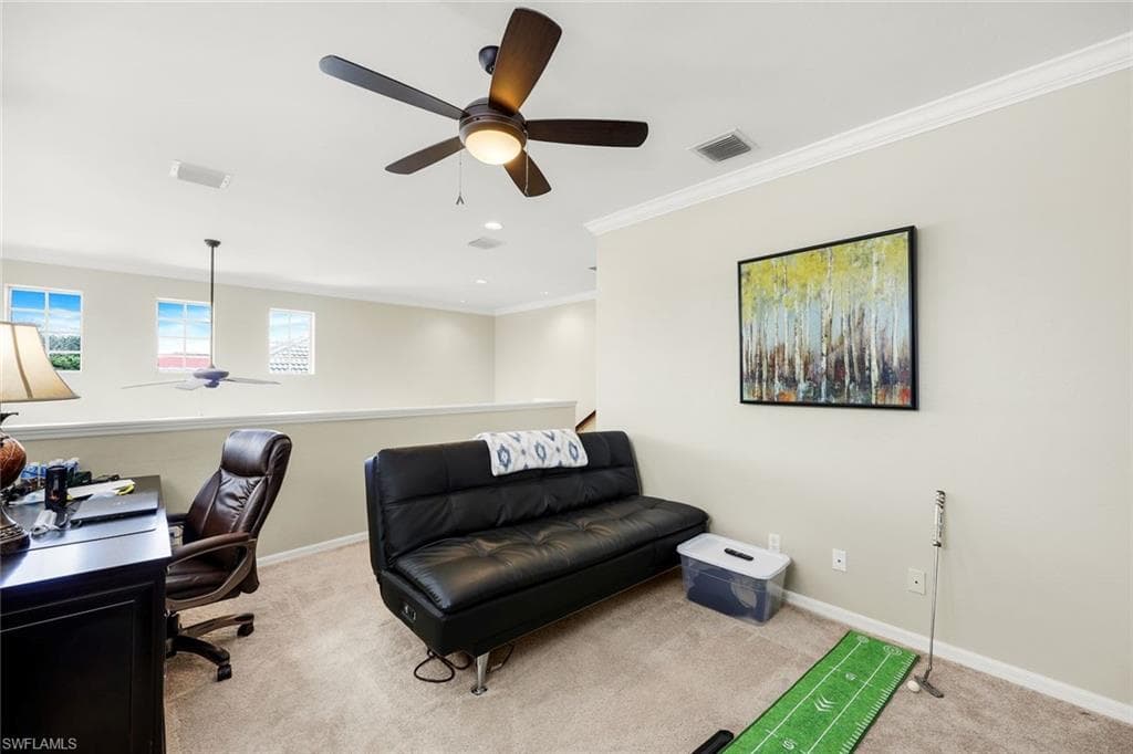 Office featuring a ceiling fan, light carpet, and ornamental molding