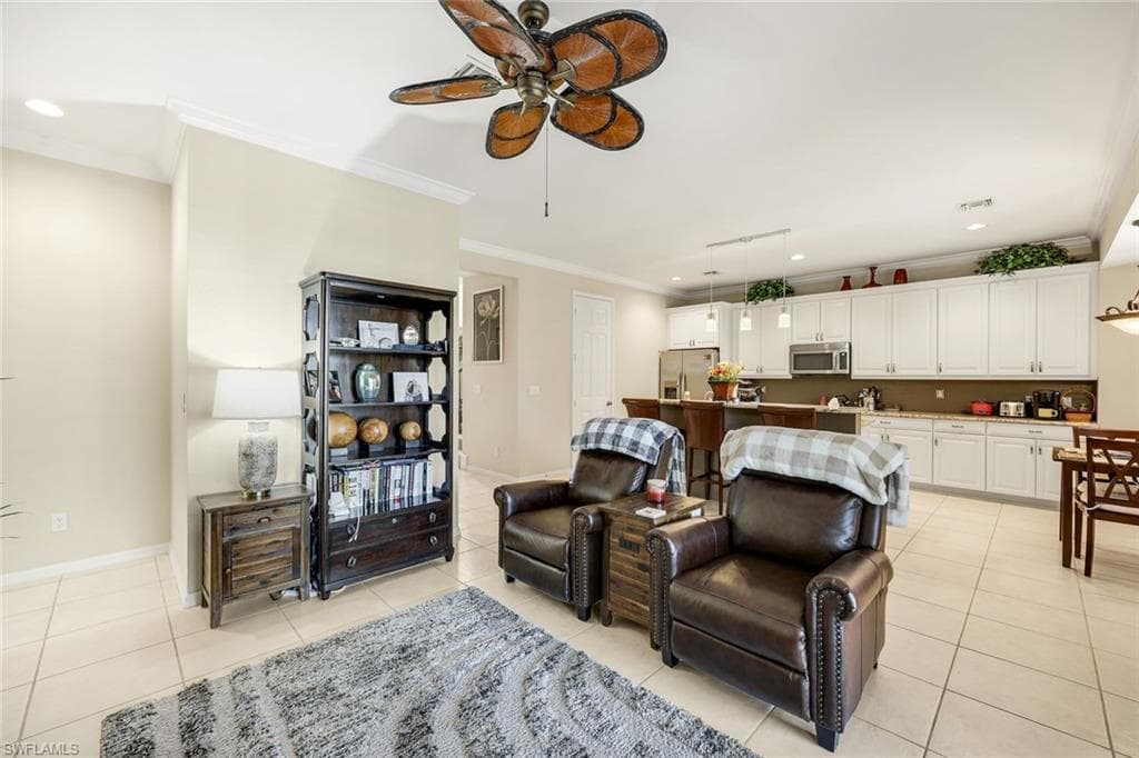 Living area featuring recessed lighting, crown molding, a ceiling fan, and light tile patterned floors
