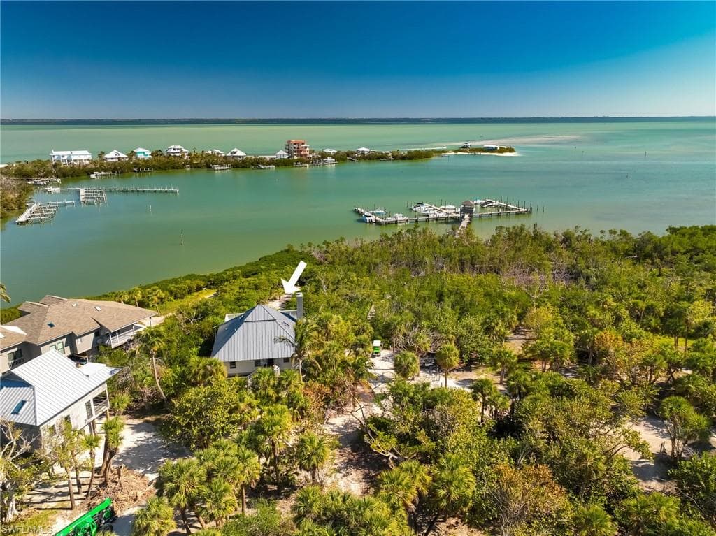Birds eye view of property with a water view