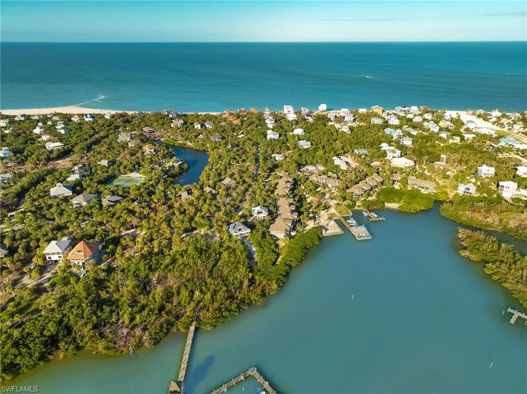 Birds eye view of property with a water view