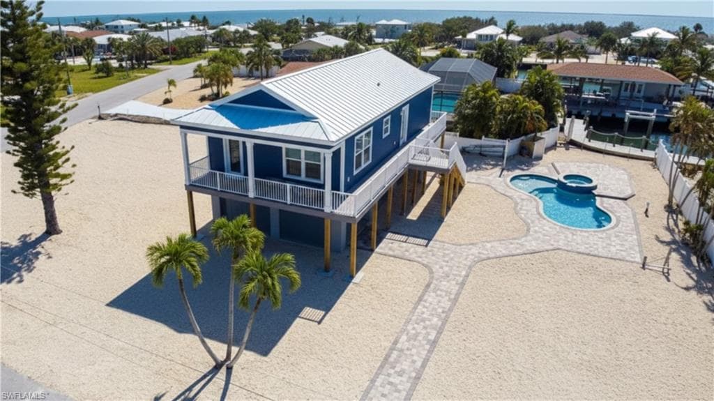 Virtually EDITED Drone shot Front view of house with pool & spa on canal- Before actual landscaping done- -VIRTUALLY EDITED